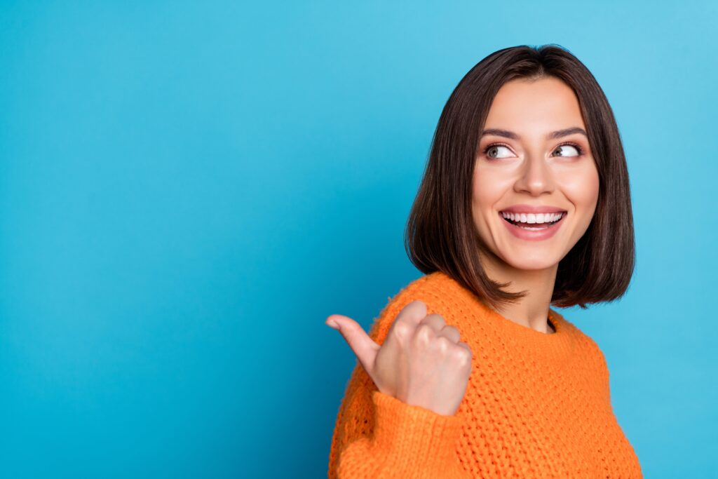 Woman smiling against a blue background