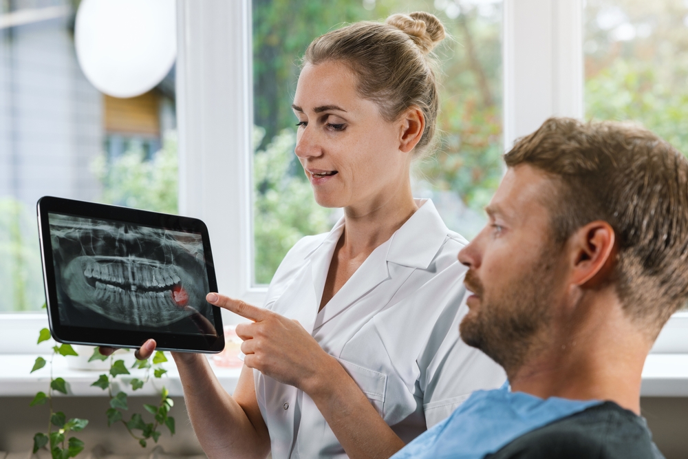Dentist explaining a dental X-ray to a patient