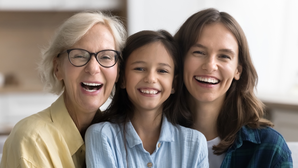 Three generations of a family smiling together